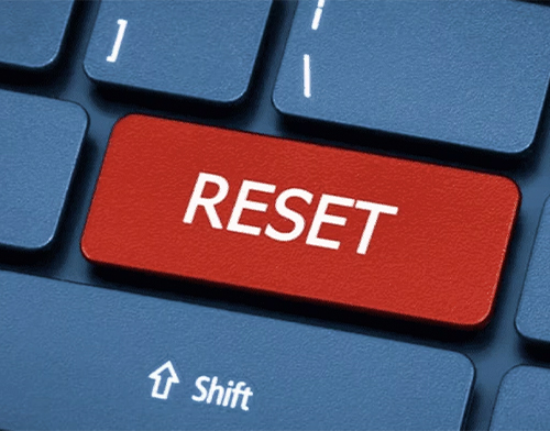 A large red "RESET" key replaces the usual position of the "Esc" key on a computer keyboard, suggesting a fresh start or restart.